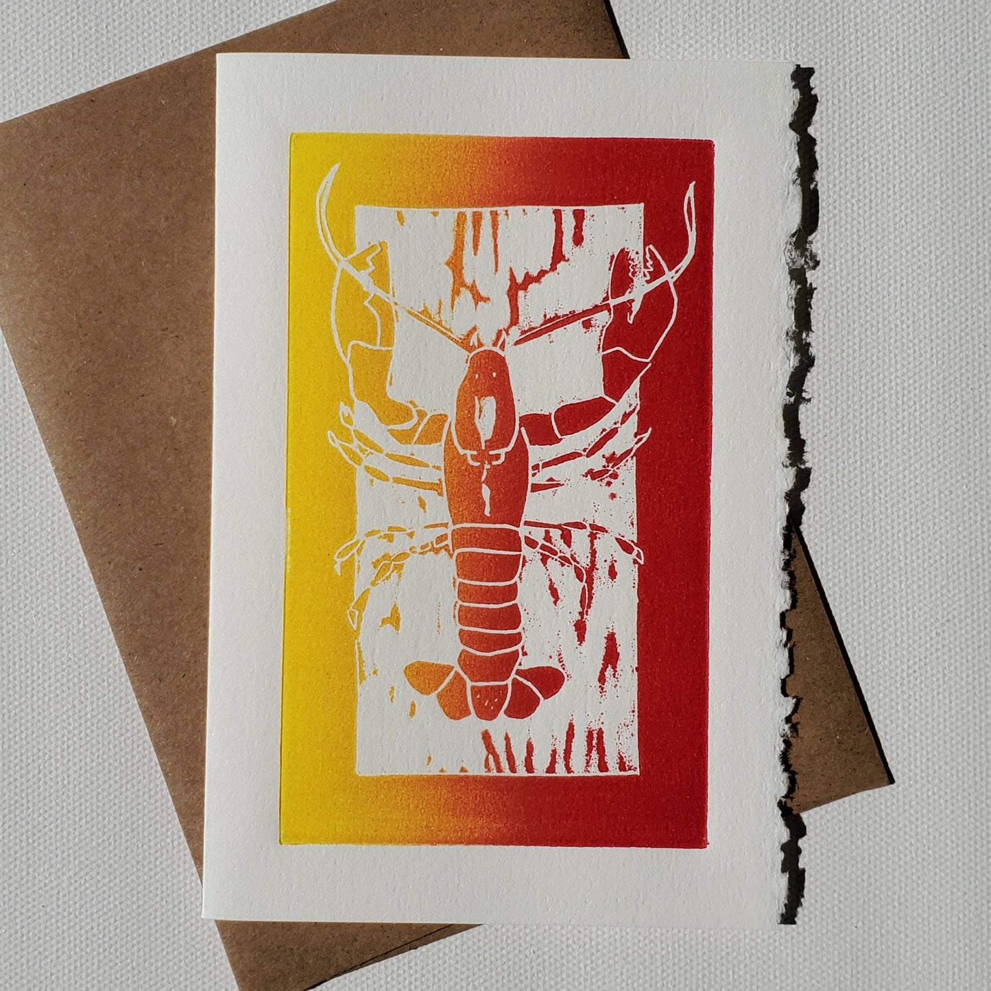 Janet Davis' Lobster linocut print on a Norton's Cove Card with its Kraft envelope