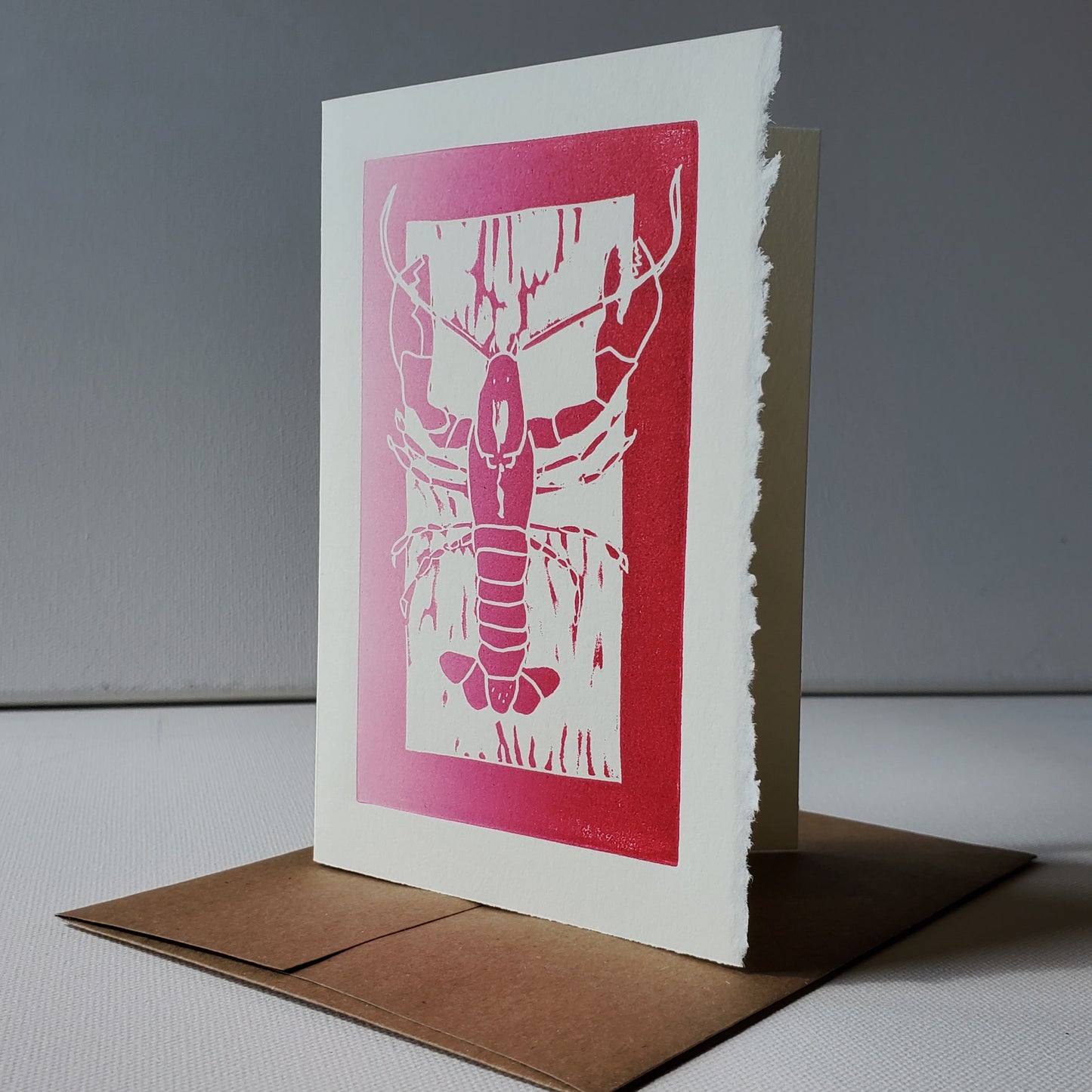 Janet Davis' Lobster linocut image printed in red ink on 100% cotton paper