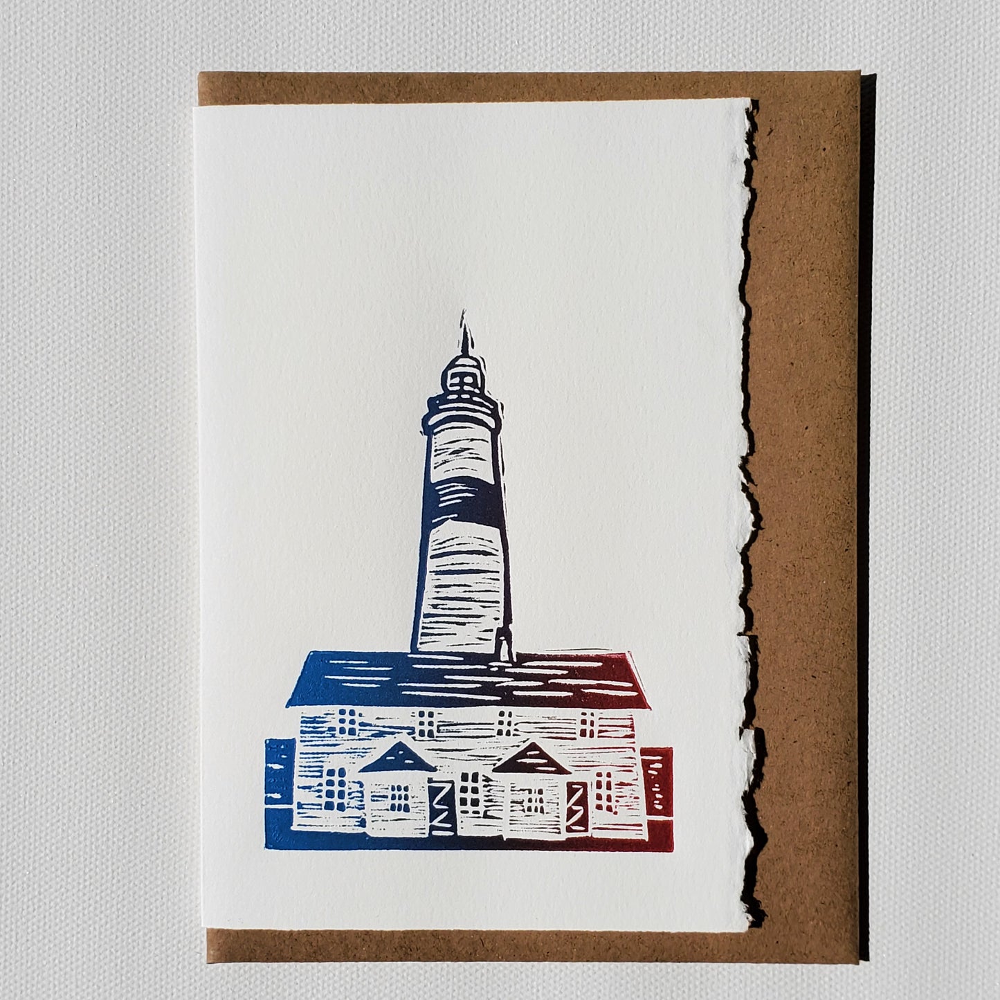 Norton's Cove Card Point Amour Lighthouse design shown in Red-Blue rainbow roll ink and a Kraft envelope