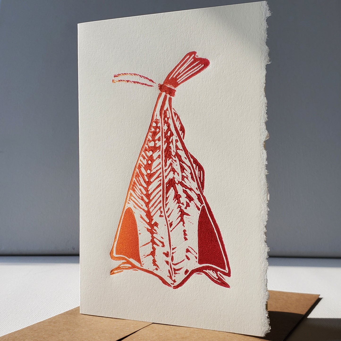 Janet Davis' Salt Fish linocut card printed in a red-yellow rainbow roll
