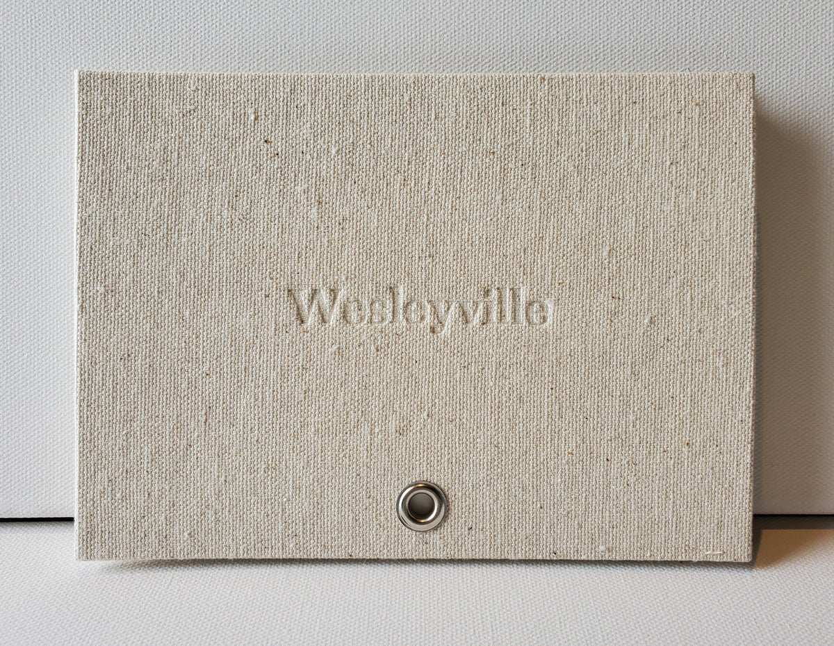 Wesleyville book front cover: sailcloth & grommet