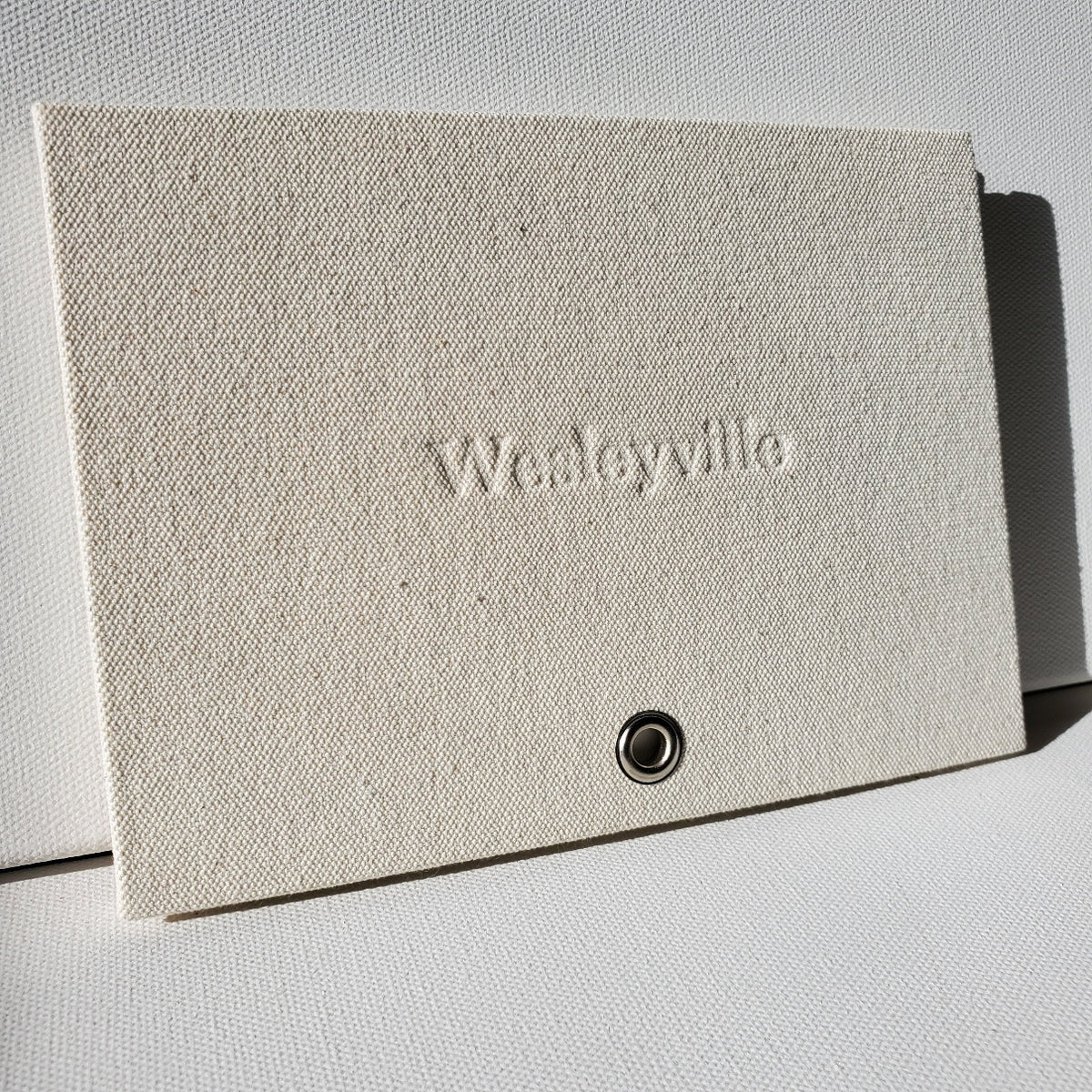 Front cover of Wesleyville art book. Sailcloth with debossed lettering and grommet for hanging