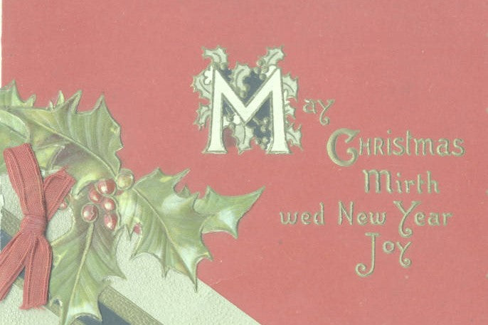 A Christmas card: red background, foreground of embossed holly/berries and a red ribbon bow.  Text reads May Christmas Mirth we New Year Joy.