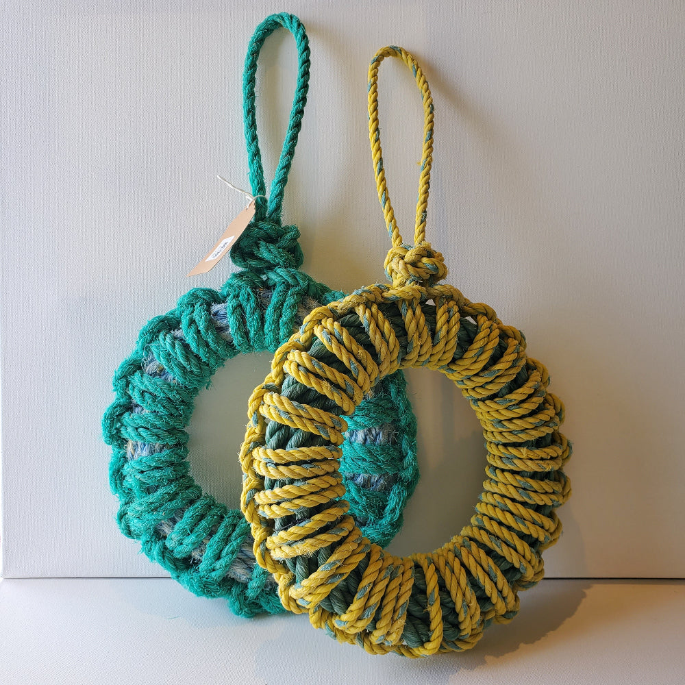 These traditional disc fenders can be used for their original purpose along the hull of your boat or sides of your wharf, or you can use it as a decorative wreath.  Made using discarded ropes from the fishing industry in Newfoundland's Bonavista Bay.