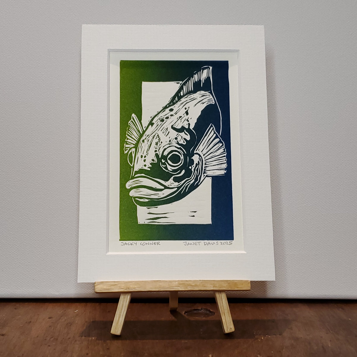 Norton's Cove Mini-Print by Janet Davis, 2025.  Cunner lino-cut printed in blue-green ink.