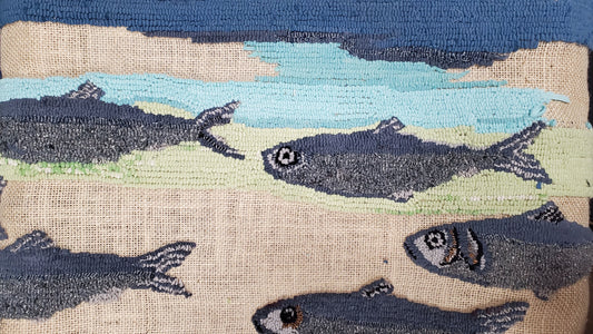 Textile art piece WIP showing fish on a natural fiber background