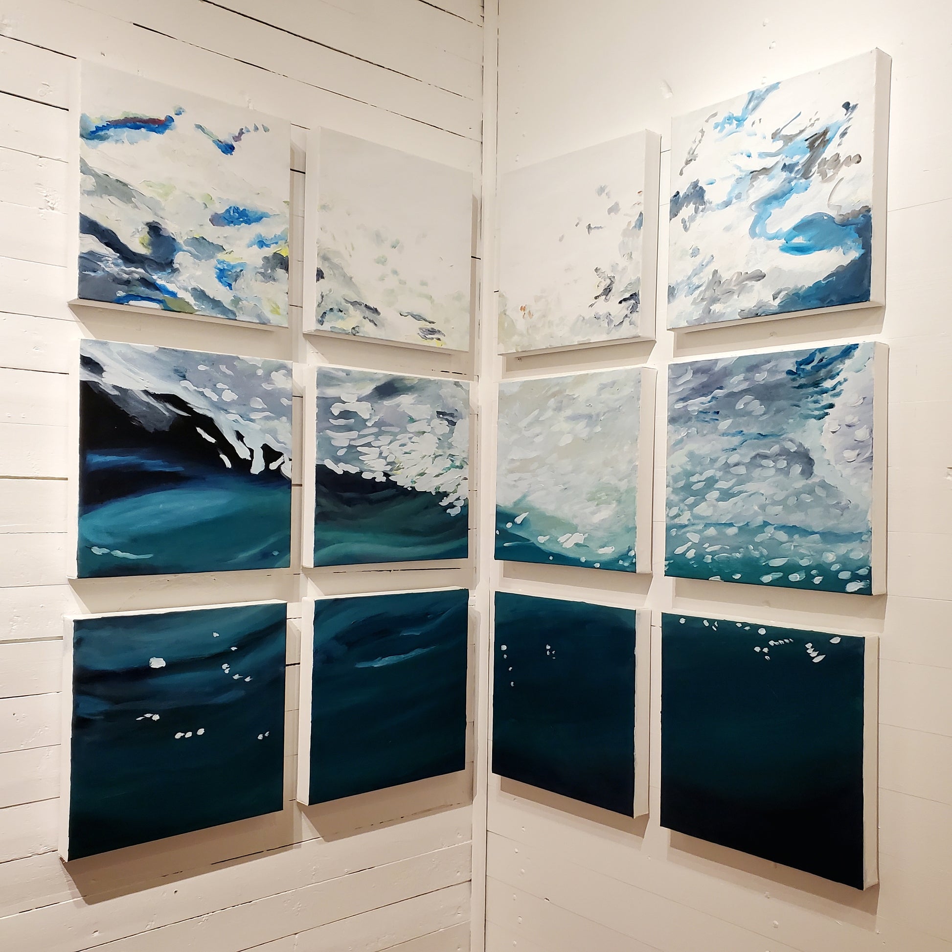 Grid of UNDERNEATH painting panels on white gallery wall at Norton's Cove Studio.  © Janet Davis
