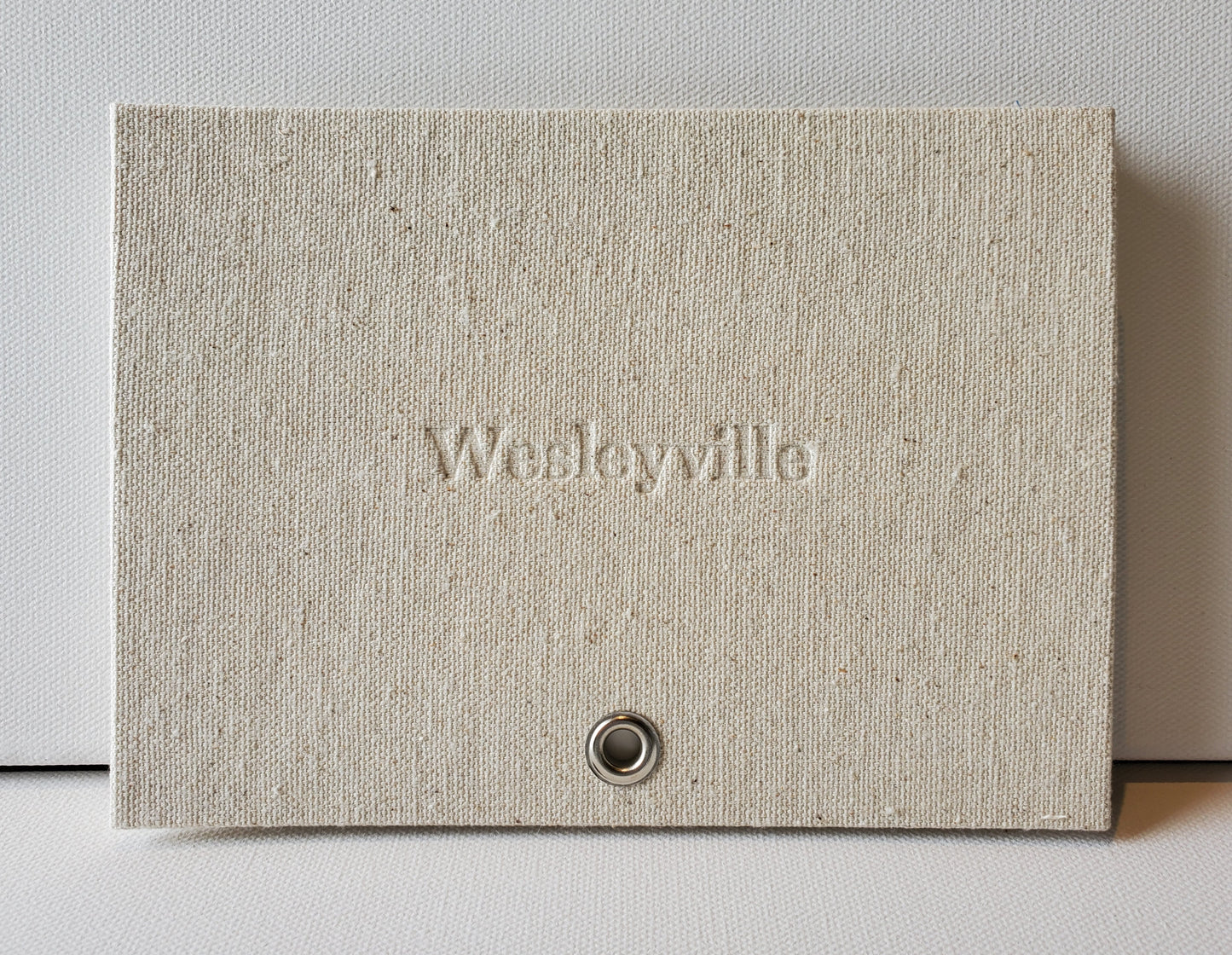 Wesleyville book front cover: sailcloth & grommet