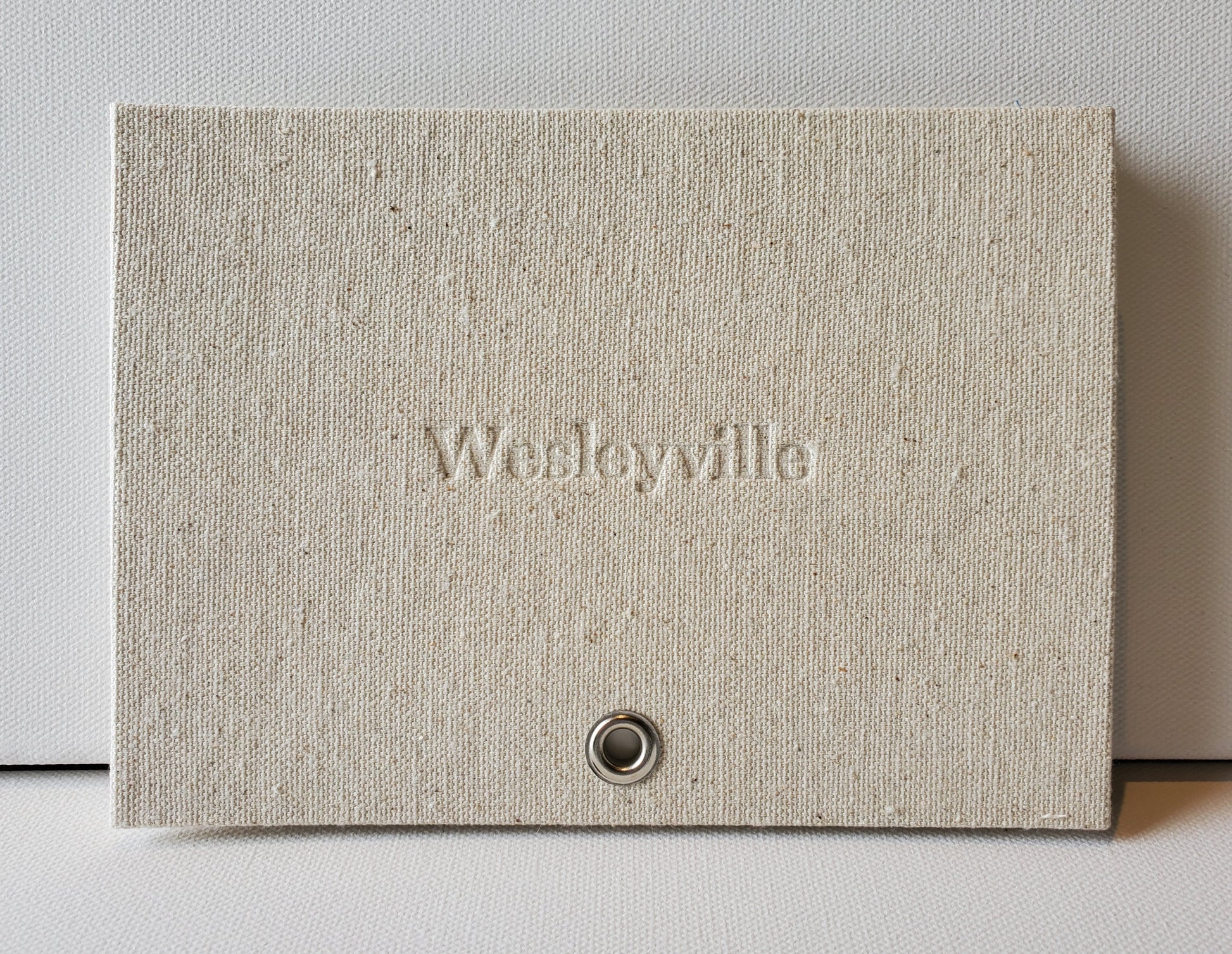 Wesleyville book front cover: sailcloth & grommet