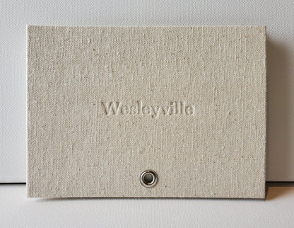 Wesleyville book front cover: sailcloth & grommet