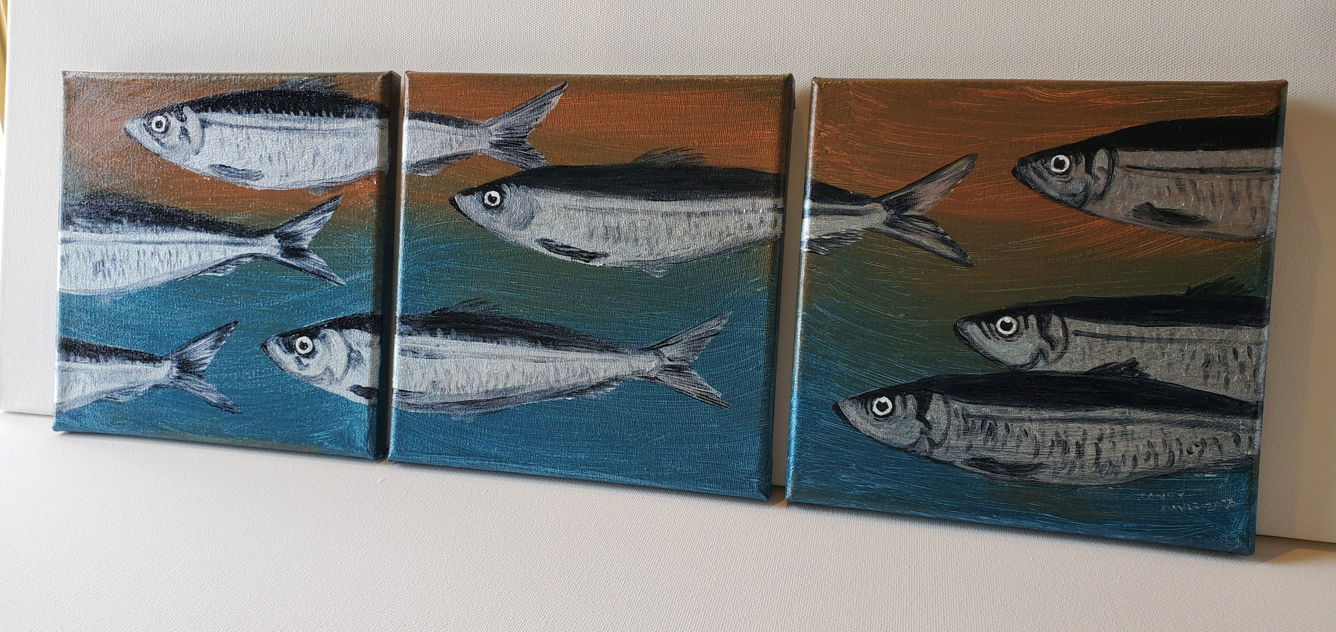 Triptych painting of herring, blue and brown background, Janet Davis 2023