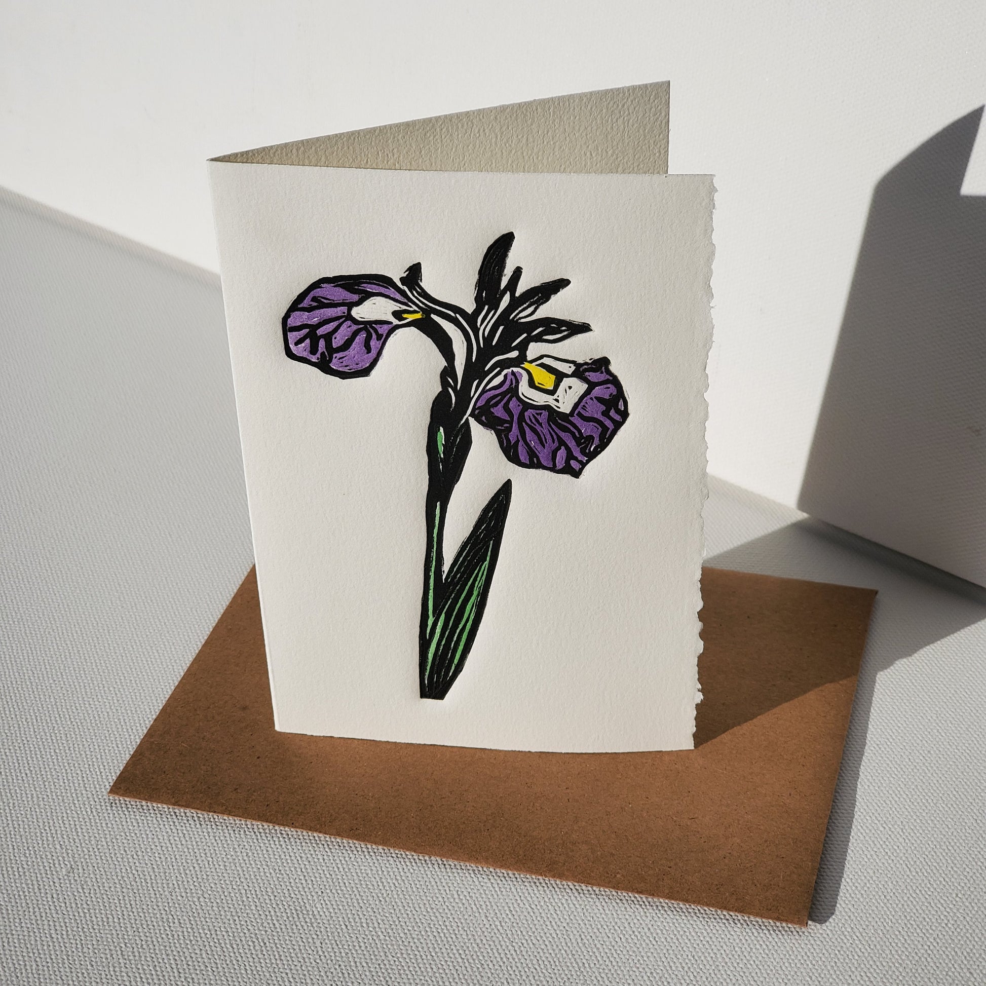 Blue Flag card standing up on Kraft envelope